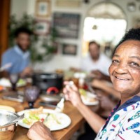 portrait of senior woman eating and looking at camera - food stock pictures, royalty-free photos & images