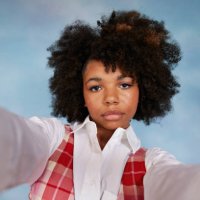 portrait of serious teenage girl with afro hairstyle taking selfie against colored background - hairstyle stock pictures, royalty-free photos & images