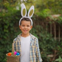 portrait of small cute boy on easter egg hunt game in back yard garden - garden decoration stock pictures, royalty-free photos & images