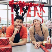 portrait of smiling co-workers in christmas shop - home decoration stockfoto's en -beelden