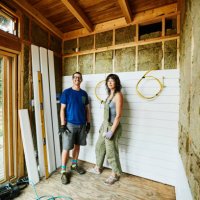 portrait of smiling couple standing in room being remodeled during home improvement project - home decoration stock pictures, royalty-free photos & images
