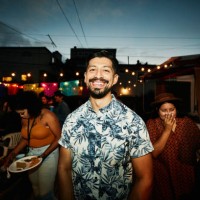 portrait of smiling man at backyard party with friends on summer evening - garden decoration stock pictures, royalty-free photos & images