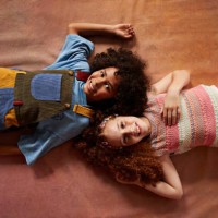 portrait of smiling multiracial girls lying together - fashion stock pictures, royalty-free photos & images