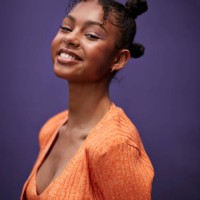 portrait of smiling teenage girl in orange casuals - fashion stock pictures, royalty-free photos & images
