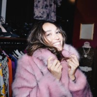 portrait of smiling woman wearing pink fur jacket at thrift store - fashion stock pictures, royalty-free photos & images