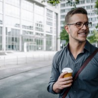 portrait of smiling young businessman with coffee to go - junk food stock pictures, royalty-free photos & images