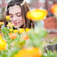 portrait of smiling young woman enjoying flowers - garden decoration stock pictures, royalty-free photos & images