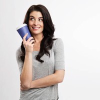portrait of smiling young woman with coffee to go - junk food stock pictures, royalty-free photos & images