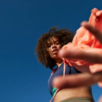 portrait of sportswoman gesturing against clear blue sky - fashion stock pictures, royalty-free photos & images