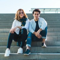 portrait of stylish young couple sitting on stairs outdoors - fashion stock pictures, royalty-free photos & images