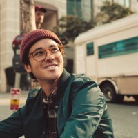 portrait of stylish young man sitting on sidewalk - fashion stock pictures, royalty-free photos & images