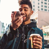 portrait of stylish young man with coffee and smartphone on the street - fashion stock pictures, royalty-free photos & images