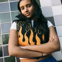 portrait of teenage girl standing with arms crossed against tiled wall - fashion stock pictures, royalty-free photos & images