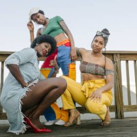 portrait of three stylish women posing on rooftop deck - fashion stock pictures, royalty-free photos & images