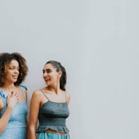 portrait of two beautiful woman against a white wall - fashion stock pictures, royalty-free photos & images