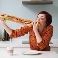 portrait of woman eating giant baguette - food stock pictures, royalty-free photos & images