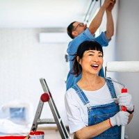 portrait of woman holding paint roller during home renovation - home decoration stock pictures, royalty-free photos & images