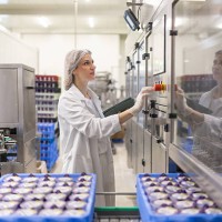 portrait of woman operating machines at food factory - food stock pictures, royalty-free photos & images