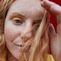 portrait of woman with freckles standing outdoors - fashion stock pictures, royalty-free photos & images