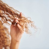 portrait of woman with natural, damaged hair and curly hair. girl with fingers in tips to show damage from hair treatment, split ends and dry hair. hair products, care and repair for healthy hair - hairstyle stock pictures, r