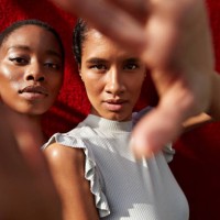 portrait of women gesturing against red wall - fashion stock pictures, royalty-free photos & images