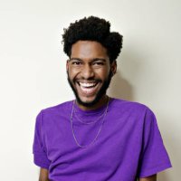 portrait of young bearded man smiling looking at camera. - hairstyle stock pictures, royalty-free photos & images