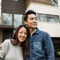 portrait of young couple in front of new home - home decoration stock pictures, royalty-free photos & images