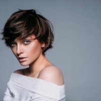 portrait of young female model with short hair on blue background - hairstyle stock pictures, royalty-free photos & images