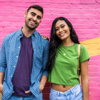 portrait of young generation z couple standing against brightly colored wall - fashion photos et images de collection