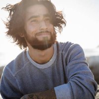 portrait of young man at beach on windy day - hairstyle stock pictures, royalty-free photos & images