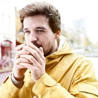 portrait of young man holding coffee cup - junk food stock pictures, royalty-free photos & images
