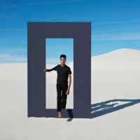 portrait of young man walking through door frame at desert - fashion stock pictures, royalty-free photos & images