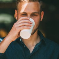 portrait of young man with coffee to go - junk food stock pictures, royalty-free photos & images