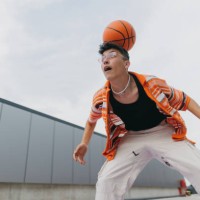 portrait of young stylish generation z boy doing basketball tricks outdoors. - fashion stock pictures, royalty-free photos & images
