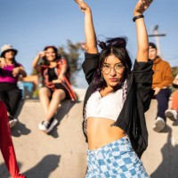 portrait of young woman dancing with her friends at street party - fashion stock pictures, royalty-free photos & images