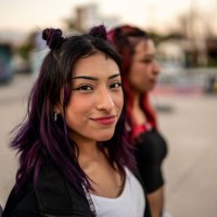 portrait of young woman walking with her friends at skateboard park - fashion stock pictures, royalty-free photos & images