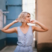 portrait of young woman wearing light blue overall in the city - fashion stock pictures, royalty-free photos & images