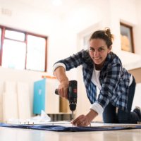 portrait woman using cordless power tool - home decoration stock pictures, royalty-free photos & images