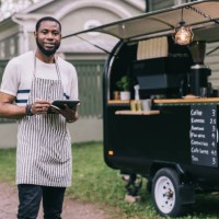positive african small business owner with his coffee trailer - junk food stock pictures, royalty-free photos & images