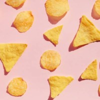 potato chips pattern over pink background, hard light with shadows. unhealthy junk food concept. - junk food stock pictures, royalty-free photos & images