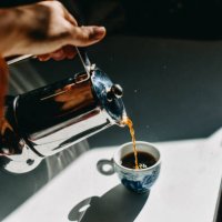 pouring espresso coffee into an espresso cup with a mocha pot. - coffee stock pictures, royalty-free photos & images