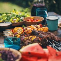 preparing lamb, beef and vegetable kebab with green salad outside - food stock pictures, royalty-free photos & images