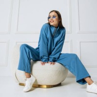 pretty fashionable young brunette woman in colorful clothes having fun sitting in armchair smiling isolated on white background in studio. happy fashion model indoors - fashion stock pictures, royalty-free photos & images