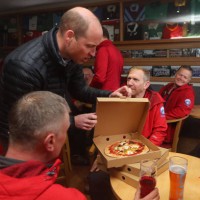 Prince William, Prince of Wales delivers take-away pizzas from a pizza van to members of the Mountain Rescue team, during a visit the Dowlais Rugby...