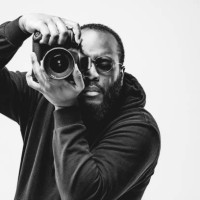 professional photographer at the studio, african american man wear black hoodie and sunglasses with digital camera is working. black and white concept photography - fashion stock pictures, royalty-free photos & images