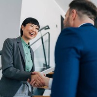 professionals meeting and shaking hands on stairs. - fashion stock pictures, royalty-free photos & images