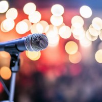 public performance on stage microphone on stage against a background of auditorium. - concert stock pictures, royalty-free photos & images