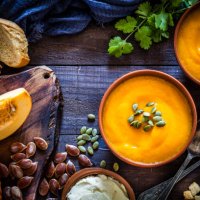 pumpkin soup with ingredients on rustic wooden table - food stock pictures, royalty-free photos & images