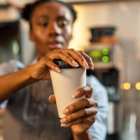 putting the lid on a coffee takeaway - junk food stock pictures, royalty-free photos & images