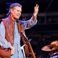 Randy Travis waves to the audience at the Concert For Carolina Benefit Concert at Bank of America Stadium on October 26, 2024 in Charlotte, North...